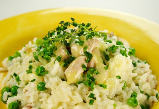 Delightful chicken and pea risotto with lemon thyme ready to serve.