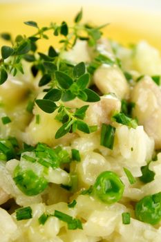 Delightful chicken and pea risotto with fresh thyme ready to serve.
