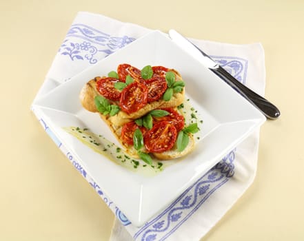 Delicious roasted cherry tomatoes with basil on bruschetta.