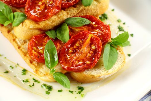 Delicious roasted cherry tomatoes with basil on bruschetta.