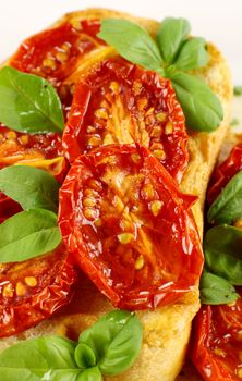 Delicious roasted cherry tomatoes with basil on bruschetta.