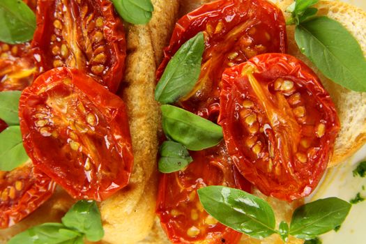 Delicious roasted cherry tomatoes with basil on bruschetta.