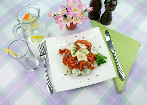 Delicious spinach gnocchi with a tomato and olive sauce.