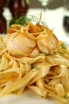 Fettucini with caramelized lemon and dill sea scallops ready to serve.