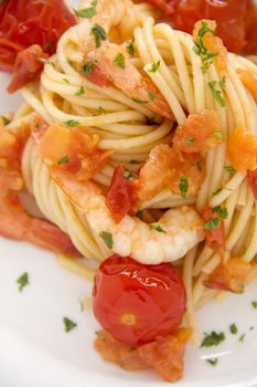 Delicious fresh shrimps and spaghetti with cherry tomatoes and parsley.