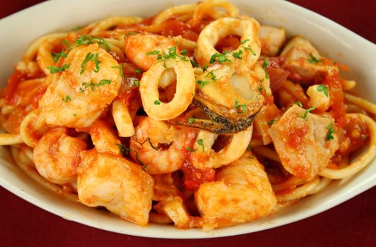 Delicious spaghetti marinara with fish, shrimps, calamari and mussels with a spicy tomato sauce.