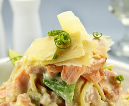 Delicious parmesan cheese on top of creamy salmon spaghetti.