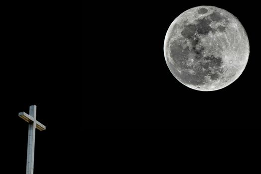 Midnight mass concept with a full moon and a Christian cross