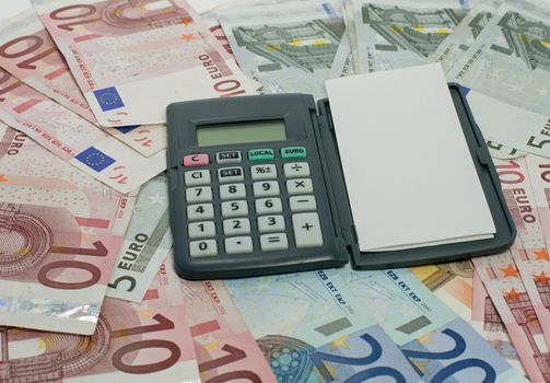 pen with paper and calculator euro money