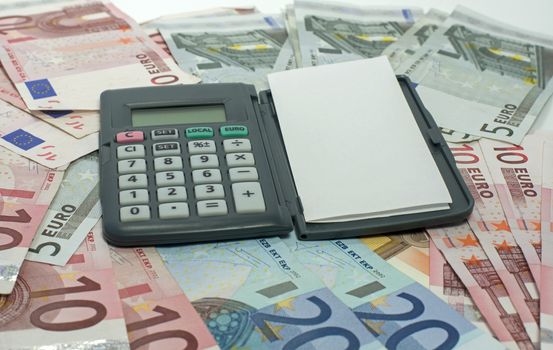 pen with paper and calculator euro money