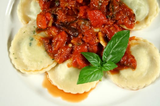 Chicken and spinach ravioli with a capsicum, olive and tomato sauce.