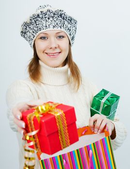 young attractive girl in a sweater holding a gift