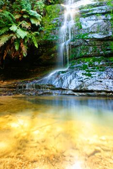 Water cascading down a rock into a shallow rockpool - Blue Mountains Australia