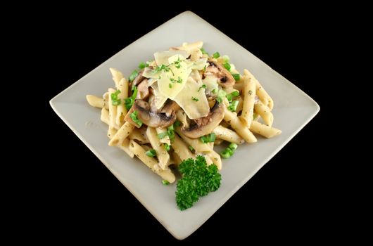 Creamy mushroom penne pasta with shredded cheese.