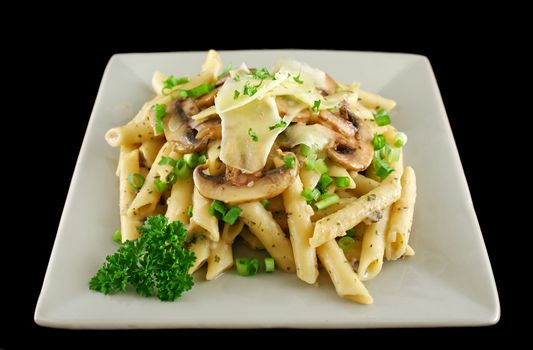 Creamy mushroom penne pasta with shredded cheese.