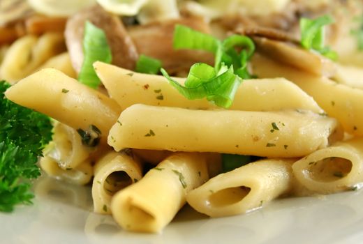 Creamy mushroom penne pasta with shredded cheese.