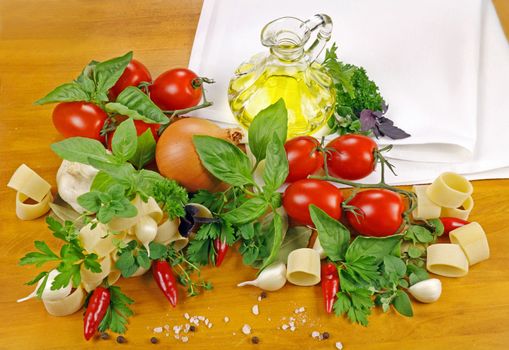 Selection of fresh ingredients required to make tomato based pasta dishes.