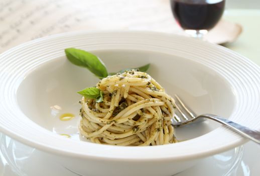 Delicious spaghetti with pesto with red wine ready to serve.