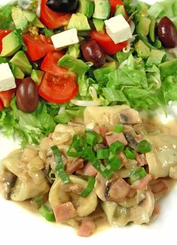 Homemade tortellini with a carbonara sauce topped with shallots and side salad.