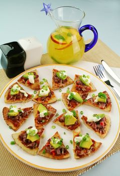 Delicious mexican triangles with avocado and sour cream with a fruit punch