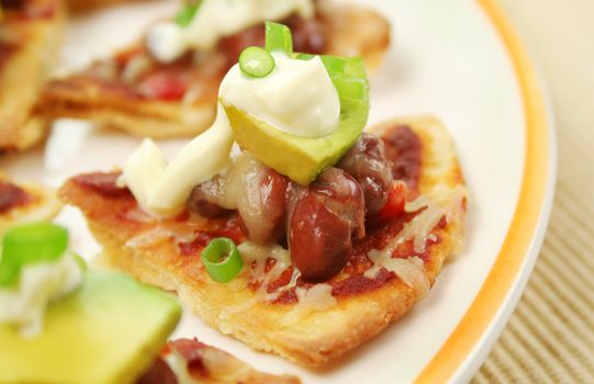 Delicious mexican triangles with avocado and sour cream