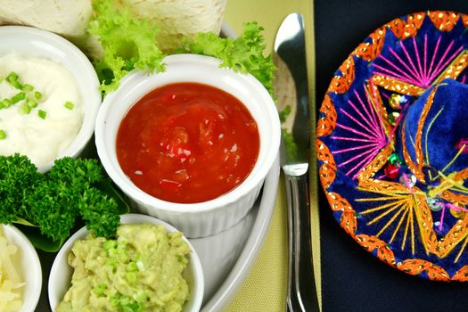 Mexican vegetarian platter with tortillas, sour cream and tomato salsa,