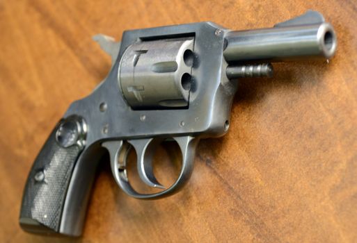 a pistol on a wood background