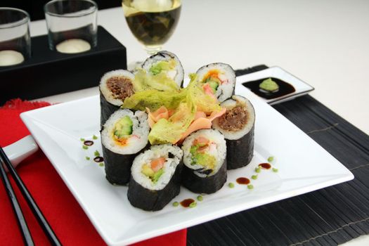 Sushi comprising prawn and avocado rolls, beef rolls and salmon and avocado rolls.