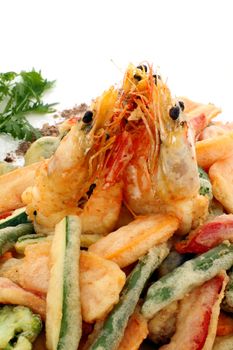 Japanese fried tempura with shrimp and vegetables with parsley garnish.