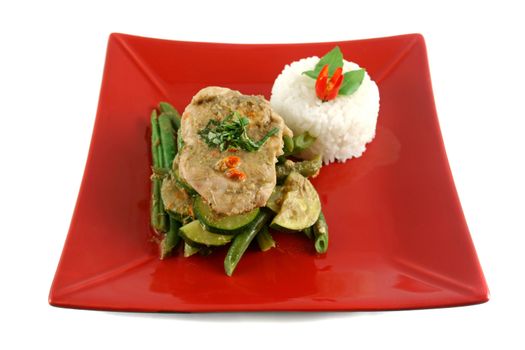 Delicious Thai green poached chicken with green beans and zucchini and rice.