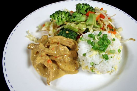 Delicious pork curry and rice with stirfry vegetables.