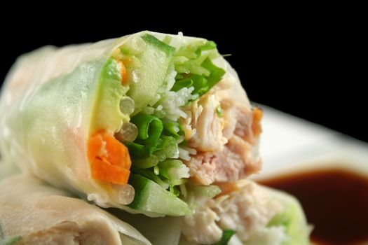 Sliced section of a healthy Vietnamese rice paper roll with chicken and vegetables.