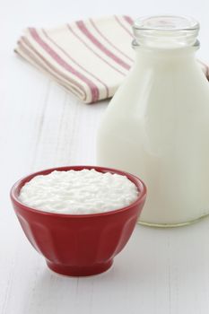 Cottage cheese and fresh milk on vintage french table linen.