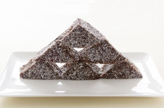 The iconic Australian cake the lamington made into a stack with chocolate and coconut.