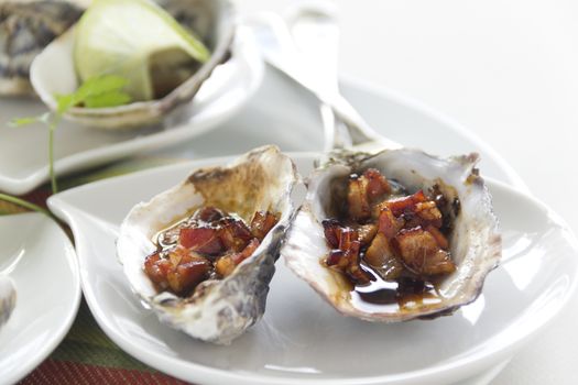 Delicious oysters kilpatrick with bacon and worcestershire sauce ready to serve.