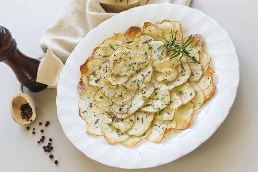 Delicious crispy baked potato chips with rosemary ready to serve.