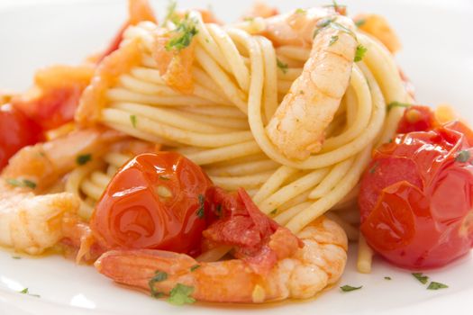 Delicious fresh shrimps and spaghetti with cherry tomatoes and parsley.