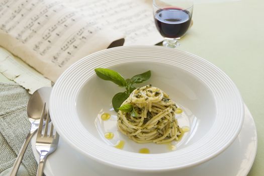 Delicious spaghetti with pesto with red wine ready to serve.