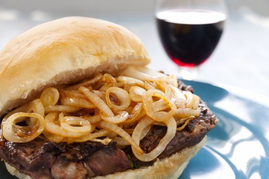 Delicious steak burger with fried onions ready to serve.