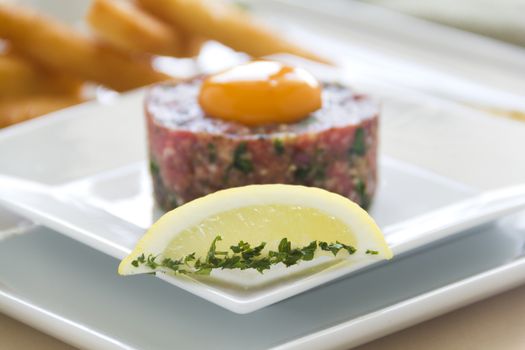 Lemon and mint with steak tartare raw egg and fried bread strips ready to serve.