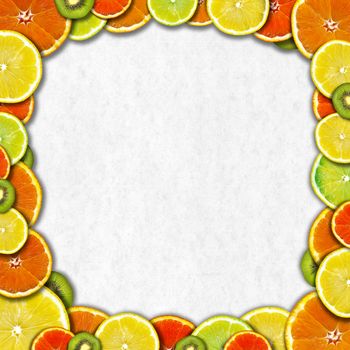 Frame of oranges, lemons and kiwi on a gray paper background