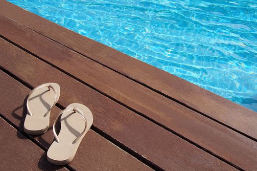 Men's flip-flops by the swimming pool