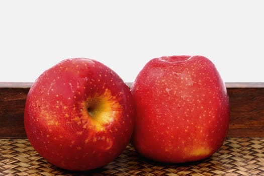 Three apples on bamboo