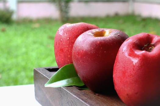 Three apples on the wood