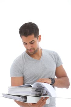 Young handsome man reading using a pile of folders in a close up shot