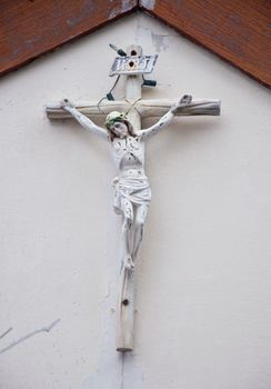 old Jesus statue on wall of christian chruch