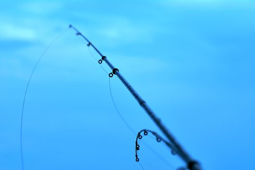 fishing rods on the background of blue water