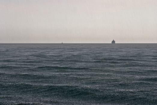 sea in the rain, dark water and gray sky