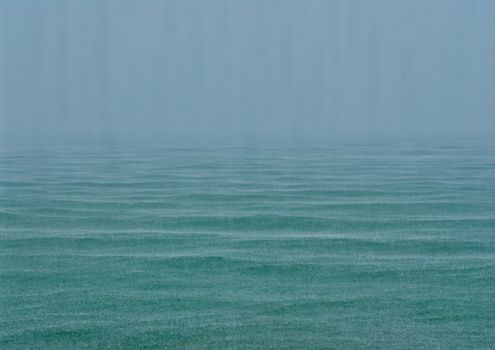 sea in the rain, dark water and gray sky