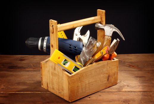 wooden tool box at work on a black background